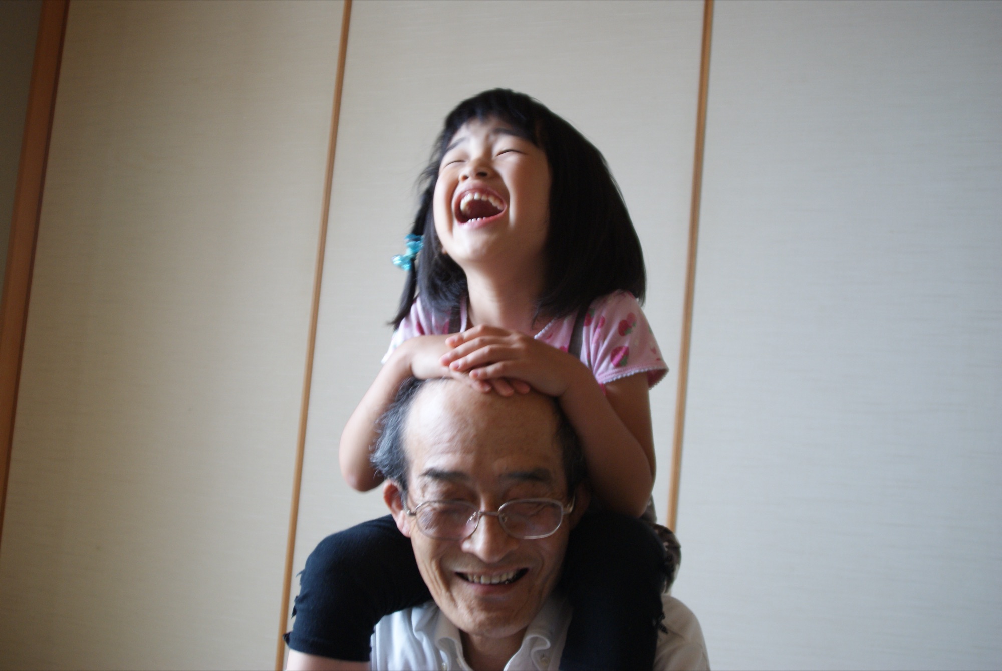 Mia laughing on Jiji's shoulders
