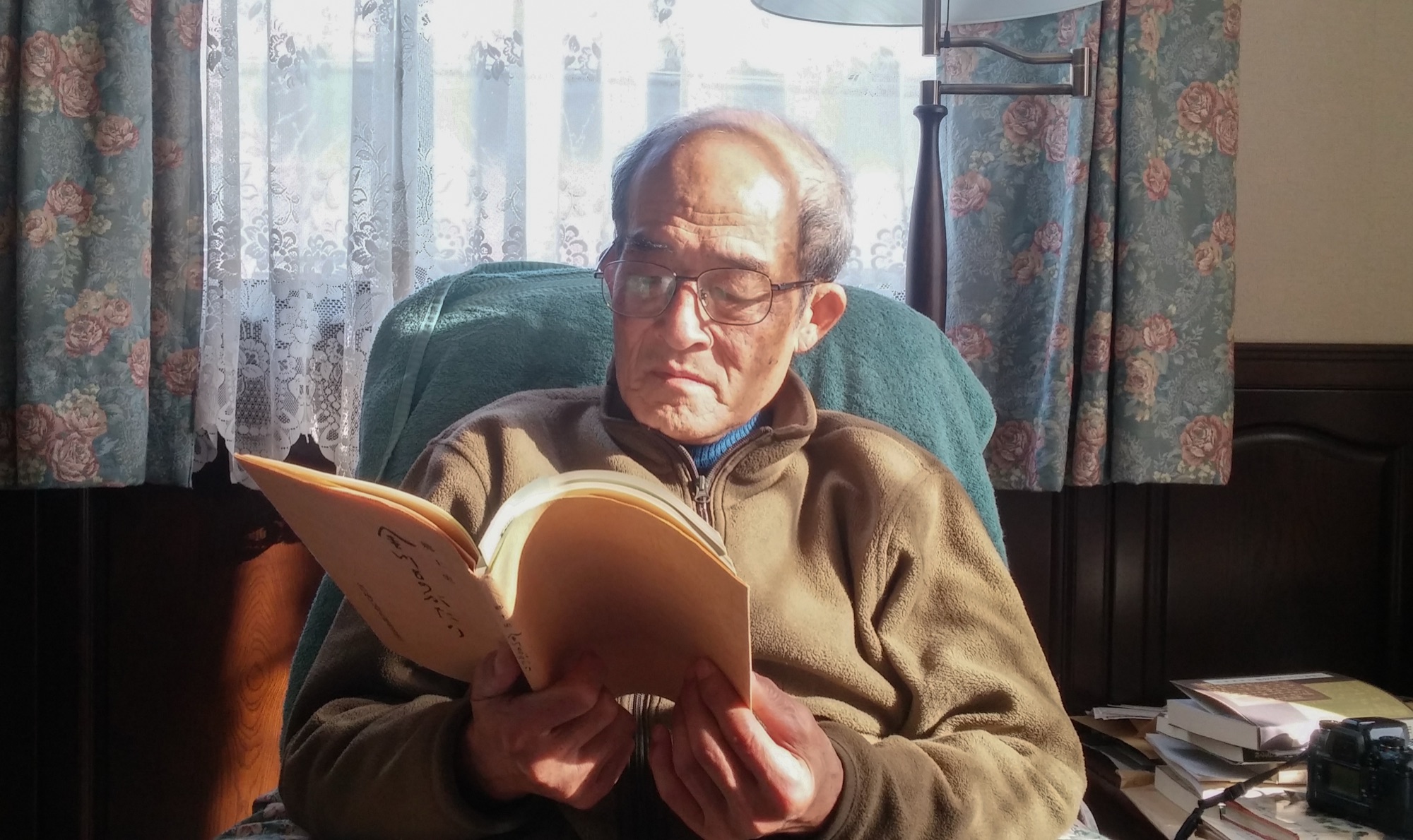 Itazu-san reading by the window